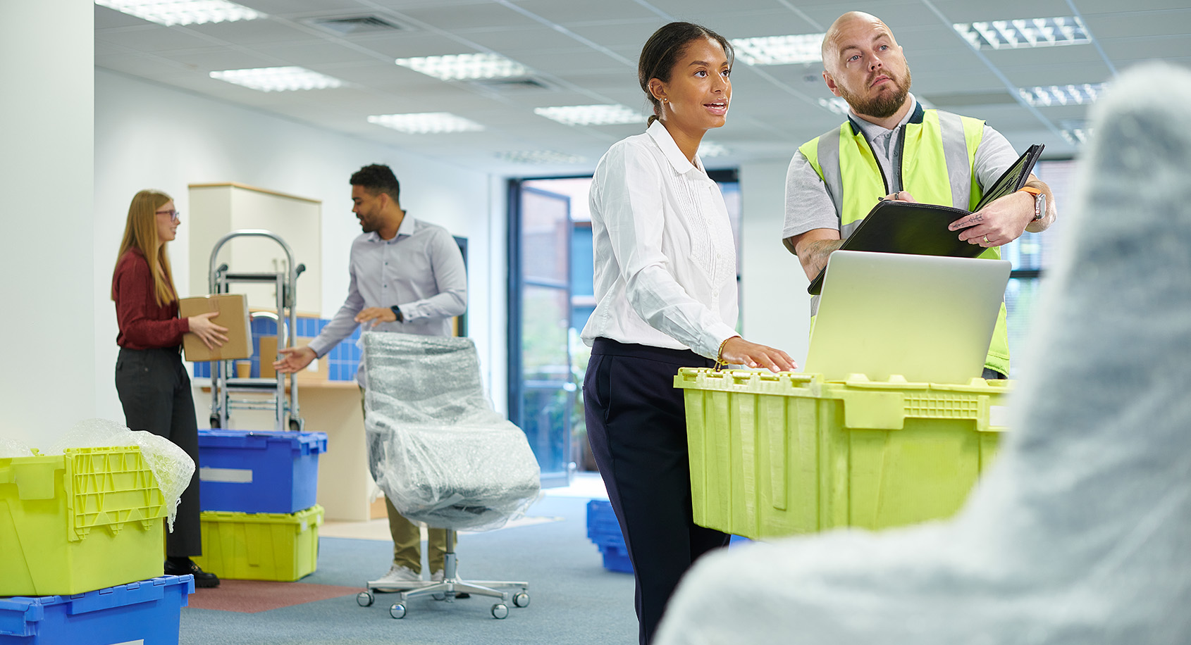People in an office packing for a move