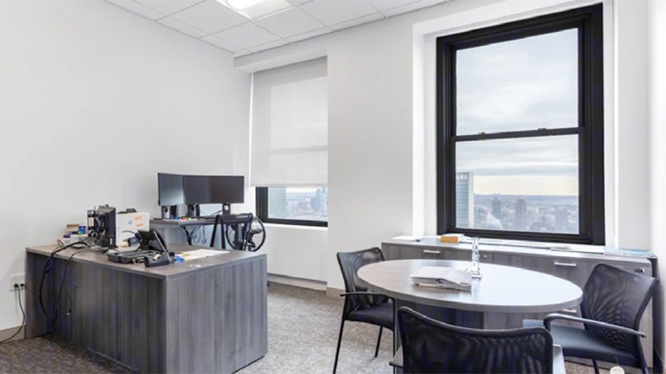 Office with a small meeting table at 220 E 42nd St, New York