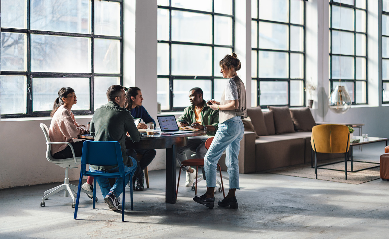 People sitting at a large table having a meeting