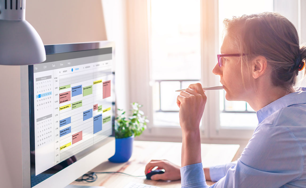 Woman looking at calendar on computer