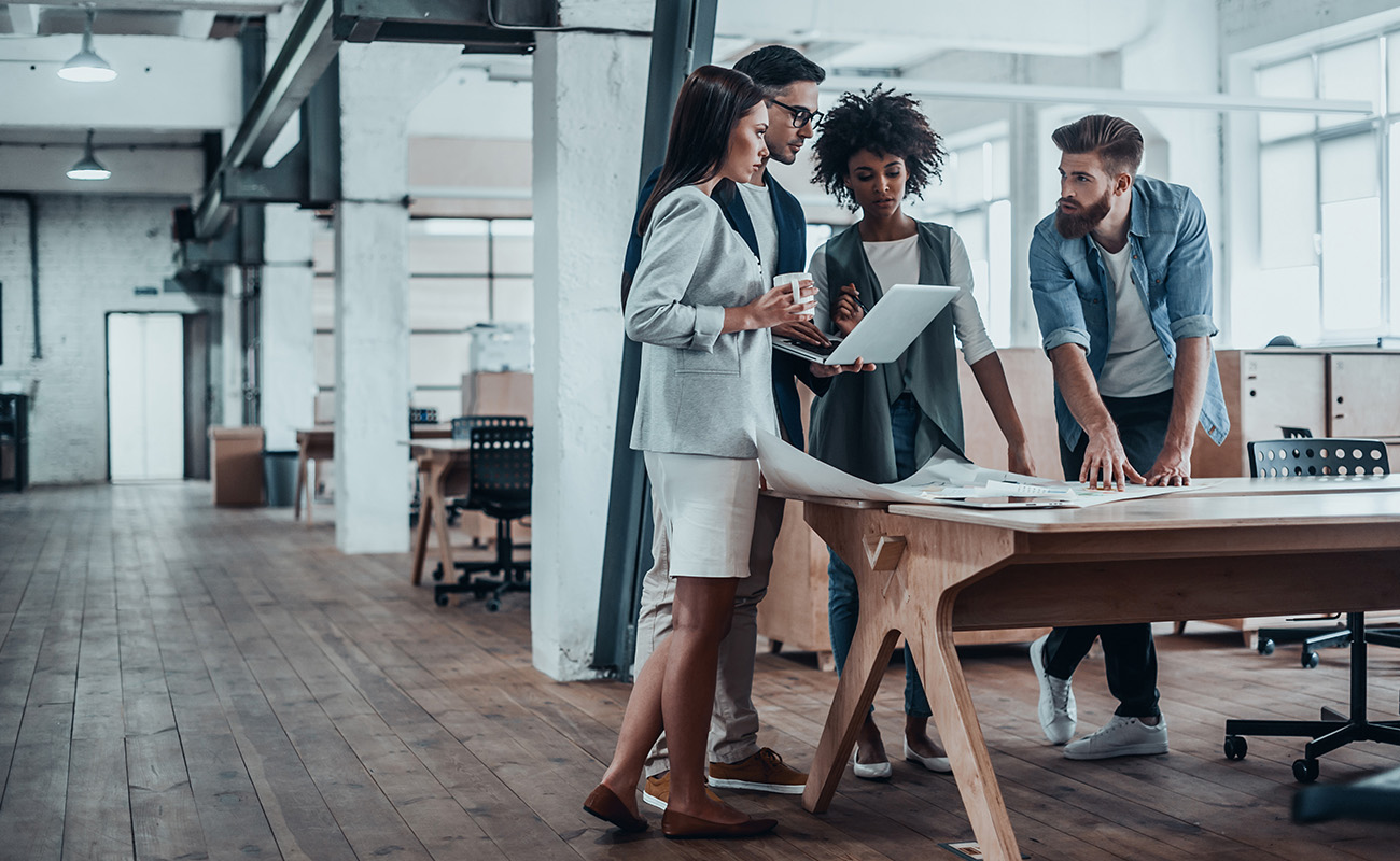 Poeple working at a conference table standing up